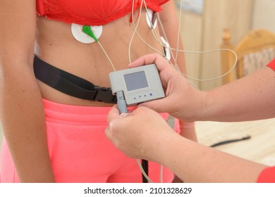 Electrocardiography ECG Leads For A Portable Heart Monitor On An Young Woman Patient. The Nurse Connects The ECG Device To The Patient