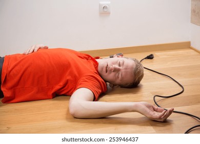 Electrocuted unconscious electrician lying on the floor