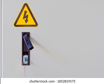 Electrocution hazard icon sticker on power panel door.