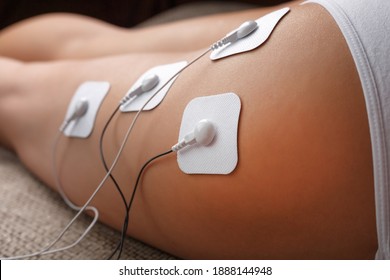 Electrode Stimulating Massage Of The Buttocks And Legs At Home. Medical Procedure For Muscle Tone And Beauty