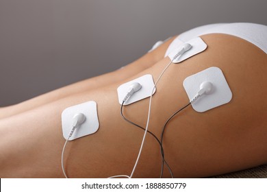 Electrode Stimulating massage of the buttocks and legs at home. Medical procedure for muscle tone and beauty
