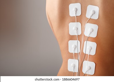 Electrode Stimulating Massage Of The Spine At Home. Medical Procedure For Muscle Tone And Beauty