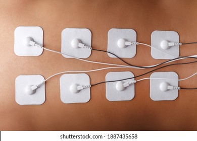 Electrode Stimulating Massage Of The Spine At Home. Medical Procedure For Muscle Tone And Beauty