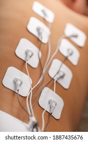 Electrode Stimulating Massage Of The Spine At Home. Medical Procedure For Muscle Tone And Beauty