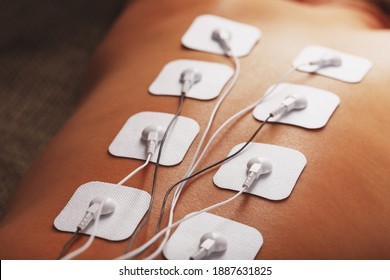 Electrode Stimulating Massage Of The Spine At Home. Medical Procedure For Muscle Tone And Beauty Soft Contrast