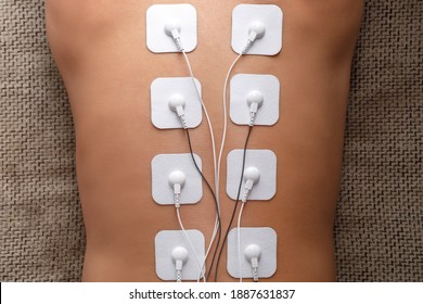 Electrode Stimulating Massage Of The Spine At Home. Medical Procedure For Muscle Tone And Beauty