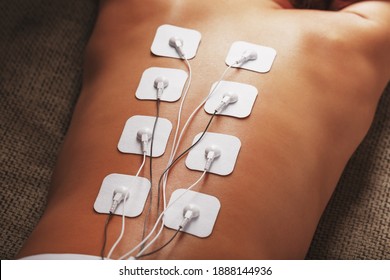 Electrode Stimulating Massage Of The Spine At Home. Medical Procedure For Muscle Tone And Beauty Soft Contrast