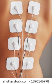 Electrode Stimulating Massage Of The Spine At Home. Medical Procedure For Muscle Tone And Beauty Soft Contrast