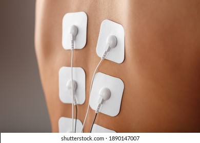 Electrode Stimulating Massage Of The Spine At Home. Medical Procedure For Muscle Tone And Beauty