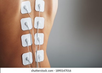 Electrode Stimulating Massage Of The Spine At Home. Medical Procedure For Muscle Tone And Beauty Soft Contrast