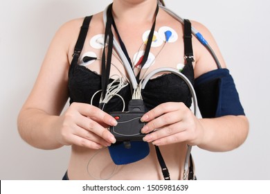 Electrodes Holter monitoring and blood pressure monitor system on the chest of a woman.