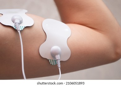 Electrodes on biceps muscles. Electrodes for electric stimulator.
