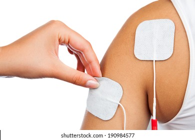 electrodes of tens device on shoulder, tens therapy, nerve stimulation