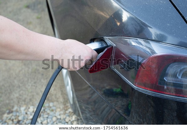 Electromobile.\
Charging the car with an electric\
outlet.