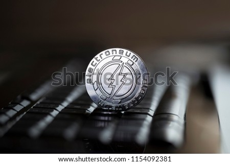 Electroneum cryptocurrency physical coin placed on the keyboard