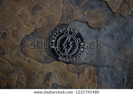 Electroneum cryptocurrency physical coin placed on the stone floor