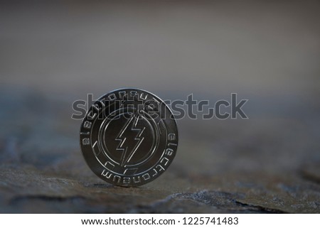 Electroneum cryptocurrency physical coin placed on the stone ground