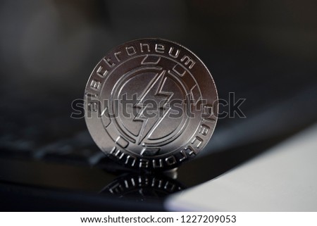 Electroneum cryptocurrency physical coin placed on the of the keyboard