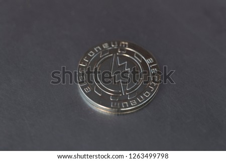Electroneum cryptocurrency physical coin placed on the metal surface