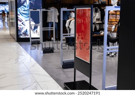 Electronic anti-theft gate system at retail shop entrance to deter shoplifting
