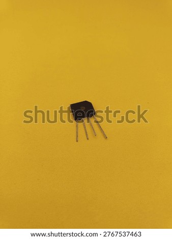 Electronic bridge rectifier diode component with four pins isolated on a bright yellow background. Professional hardware part for power supply and voltage conversion circuits.