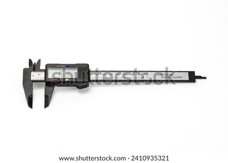 Electronic caliper for measuring on white background.