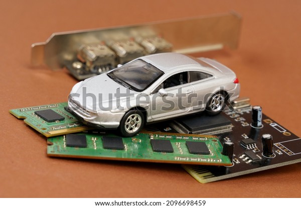 Electronic cars. There is a\
car on microcircuits, memory and electronic board. Isolated on\
brown background.