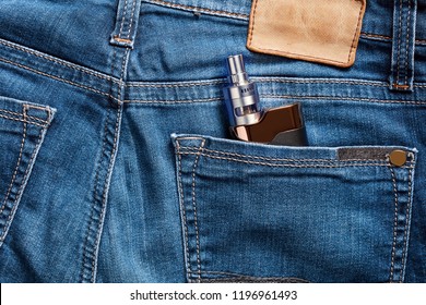 Electronic Cigarette In The Back Pocket Of A Blue Jean. Concept Of Vaping Youth.