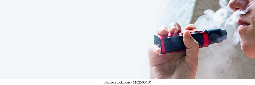 Electronic cigarette in girl hand with clouds 