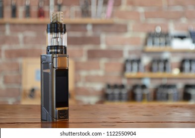 Electronic cigarette on a background of vape shop. E-cigarette for vaping. Popular vape devices