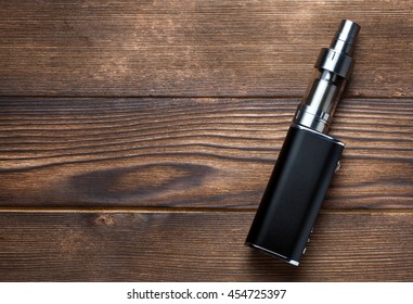 electronic cigarette on brown wooden background