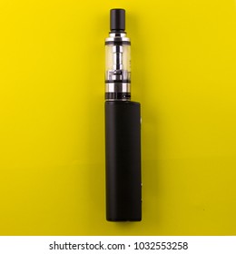 electronic cigarette on yellow background. Electronic cigarette for vaping. Popular devices of the year-a modern vaping device. Stop Smoking, start vaping vape