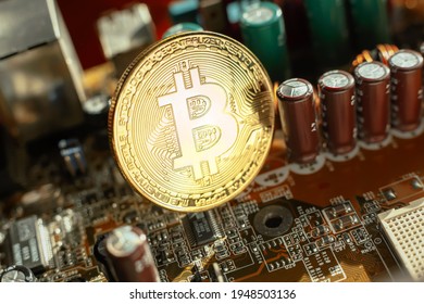 Electronic circuit blur. Bitcoin coin on electronic board