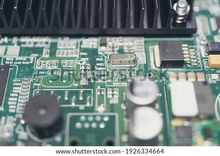 Electronic circuit board with electronic components close up. Blurry background.