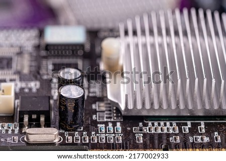 electronic circuit and cooling fin at computer video card, stack with used video cards, close-up