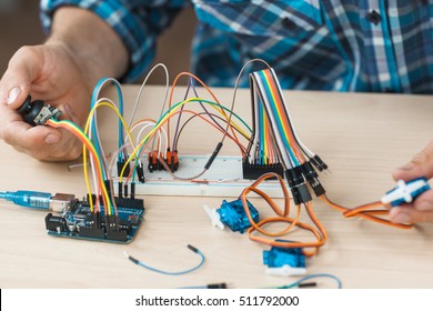 Electronic component connected with breadboard in laboratory. electrical engineering with cables and controller. Modern technologies, electronics, diy product engineering