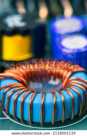 Electronic component, induction coil with copper wire winding on magnetic ferrite core on circuit board