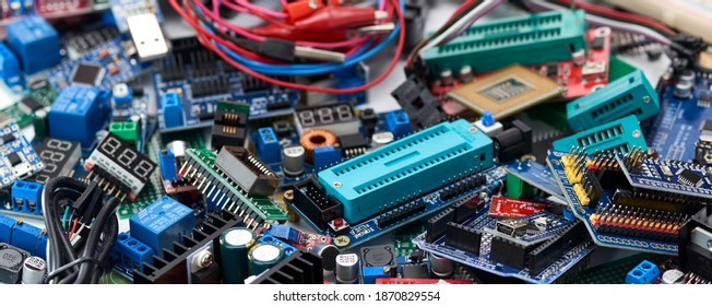 The electronic components of Arduino microcontrollers and programmers are piled up.Concept.Selective focus