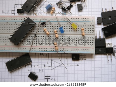 Electronic components in laboratory. Analog integrated circuits, resistors, LEDs on a breadboard. 