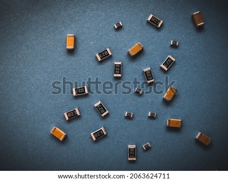 Electronic components, many ceramic capacitors and chip resistors on PCB background