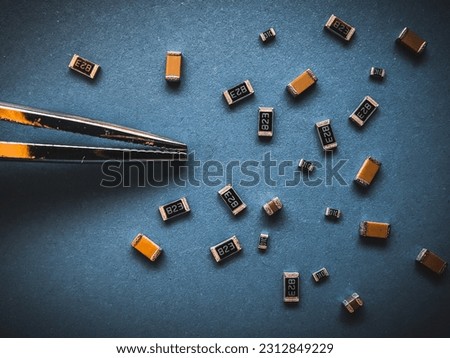 Electronic components, many ceramic capacitors and chip resistors on PCB background