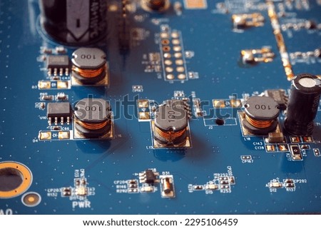 Electronic components on a motherboard. Coils, resistors and chips on the Printed Circuit Board. 