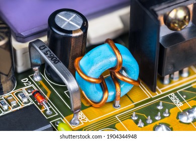 Electronic Components On Printed Circuit Board Inside Of Computer Hardware. Low Ohmic Open Air Resistor, Toroidal Inductor And Capacitor On PCB With Detail Of Ceramic Microprocessor. Electrotechnics.