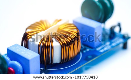 electronic components on a printed circuit board.Inductors detail. Copper wire winding.