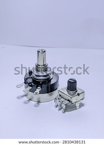 Electronic components, rotary potentiometer and trimmer isolated on white background.
