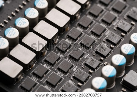 Electronic components and video card microchips. Close-up of an electronic board with SMD components. Latest generation video card. Resistors, capacitors, transistors, crystal oscillator, inductor.