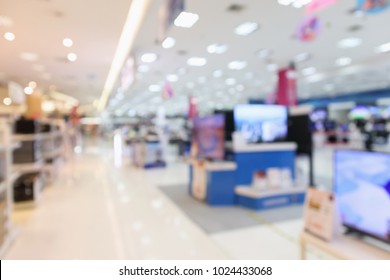 Electronic Department Store Show Television TV And Home Appliance With Bokeh Light Blurred Background