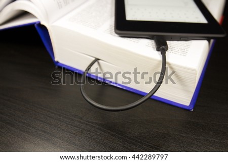 Electronic device for reading books (ereader, ebook), concept of downloading a book on the device. selective focus