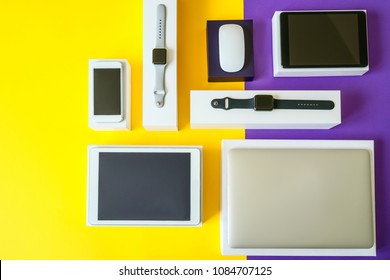 Electronic devices- computer, tablet, computer mouse, disc drive, smartphone and smart watch . Technology mock up. Colorful background, top view.