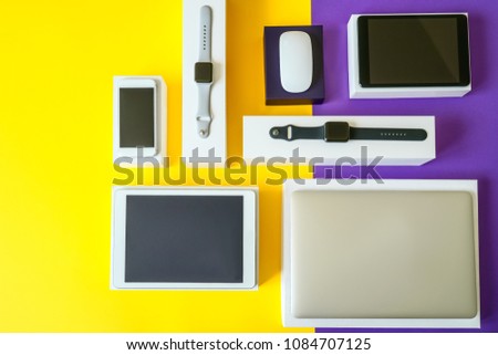 Electronic devices- computer, tablet, computer mouse, disc drive, smartphone and smart watch . Technology mock up. Colorful background, top view.